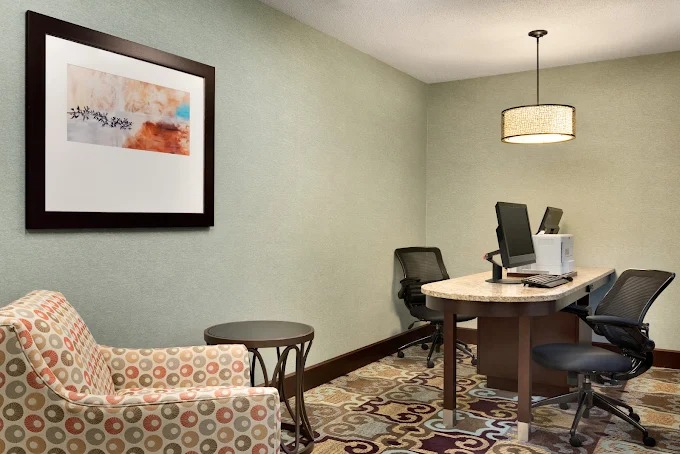 Hotel business center with computers and comfortable seating